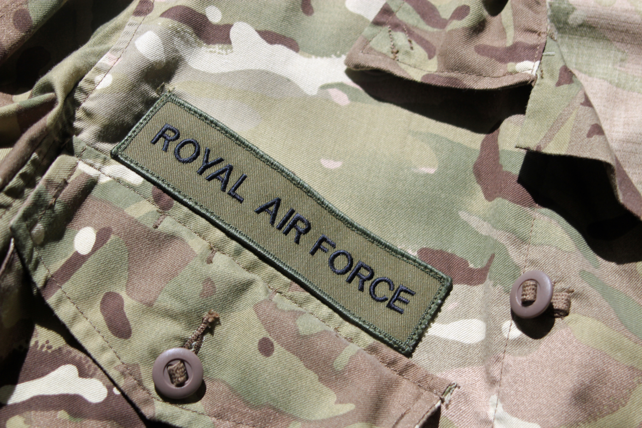 Close up of the Royal Air Force badge on a UK military camouflage uniform symbolising the UK military, RAF and the centenary of the First World War