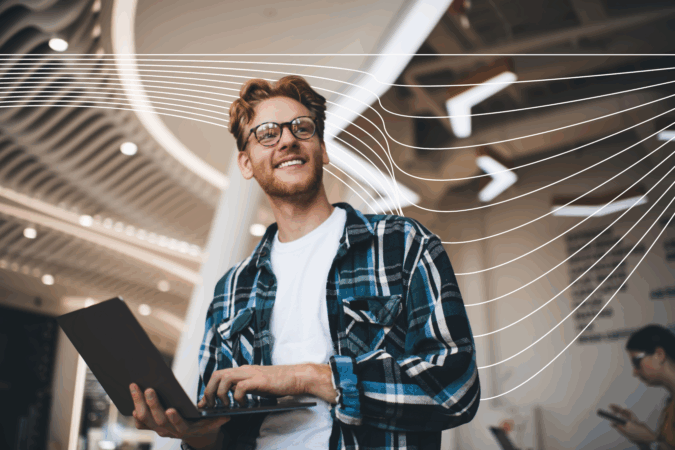 Young smiling bearded successful man in glasses