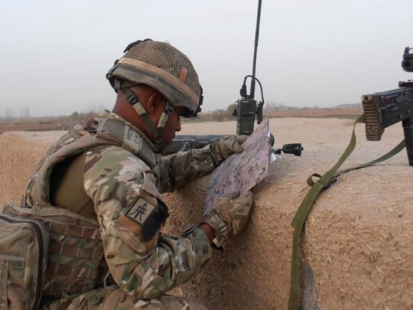 Feature image Suren looks at instructions while wearing an Army uniform